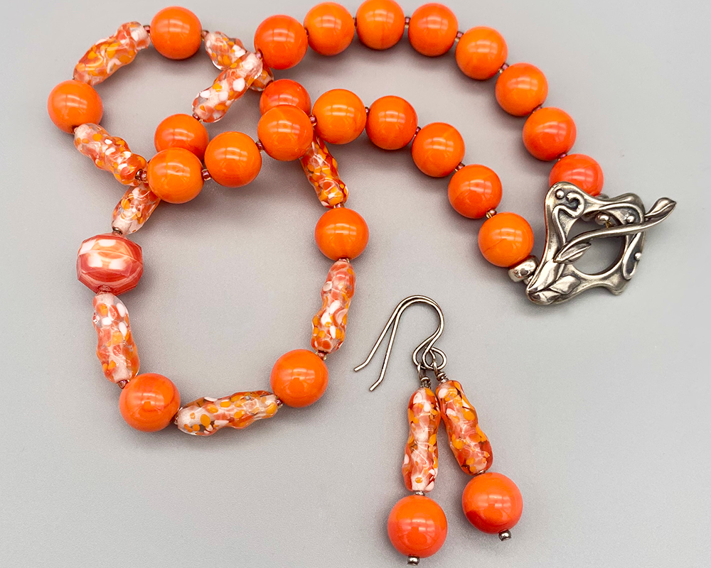 Necklace Set | Clear/orange/white baroque ovals and vivid orange vintage glass rounds
