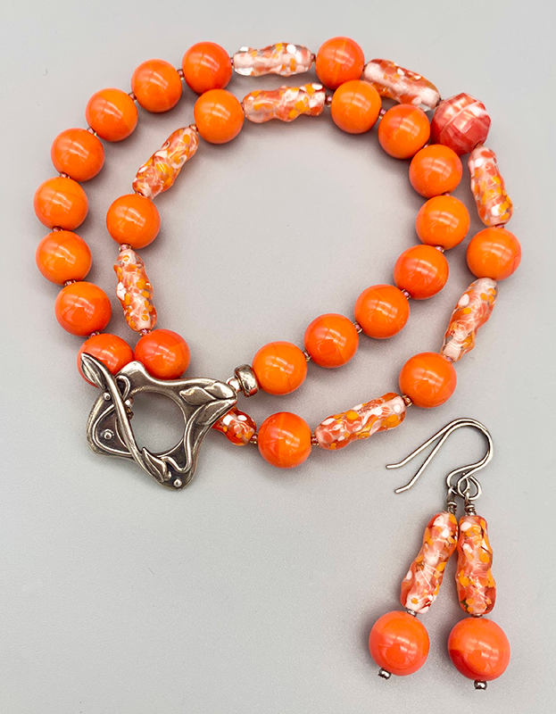 Necklace Set | Clear/orange/white baroque ovals and vivid orange vintage glass rounds